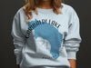 Light blue sweatshirt with Garibaldi Lake, British Columbia map graphic and compass.