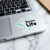 Boone Life sticker with teal lake outline on a laptop keyboard.