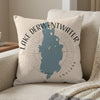Pillow with blue Lake Derwentwater map and text, in a neutral setting.