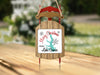 Wood sled ornament with "Merry Christmas From Lake Conroe" text.
