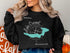 Black sweatshirt with a compass rose and map of Lake Crescent, Washington.
