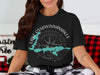 Black t-shirt with Lake Ossawinamakee, Minnesota design and compass graphic.