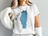 White t-shirt with "Black Lake Idaho" text and blue lake graphic.