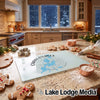 Glass cutting board featuring a blue Chain O Lakes Illinois map design on a kitchen counter with gingerbread cookies.