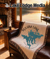 Throw blanket with Squam Lake, New Hampshire map and compass design.