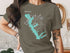 Dark grey t-shirt with turquoise Cedar Creek Lake, Texas map and compass design.