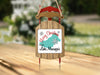 Wooden sled ornament with "Merry Christmas From Lake Mascuppic" text.