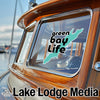 Green Bay Life sticker on a wooden boat with Lake Lodge Media logo.