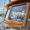 Sticker reading "Old Hickory Life" on a wooden boat window, with "Lake Lodge Media" below.