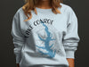 Light blue sweatshirt featuring Lake Conroe shape with compass and "Texas" text.