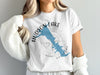 White t-shirt with blue Hudson Lake map and compass graphic, text reads "HUDSON LAKE".