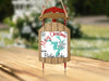 Sled ornament with "Merry Christmas from Badin Lake" text and snowflake design.