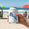 White can koozie with Clear Lake California map and compass design on a beach.