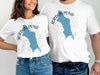 White t-shirts with blue Jordan Pond map graphic and compass design.