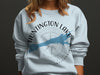Light blue sweatshirt with Huntington Lake California graphic and compass rose.