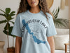 Baby blue t-shirt with Chautauqua Lake map and compass graphic, New York.