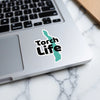 Sticker with black text "Torch Life" on a teal outline of a geographical shape.