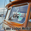 Whitney Life teal graphic on boat window with Lake Lodge Media text below.
