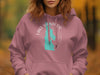 Mauve hoodie with turquoise Lake Wakanpoo map and compass design.