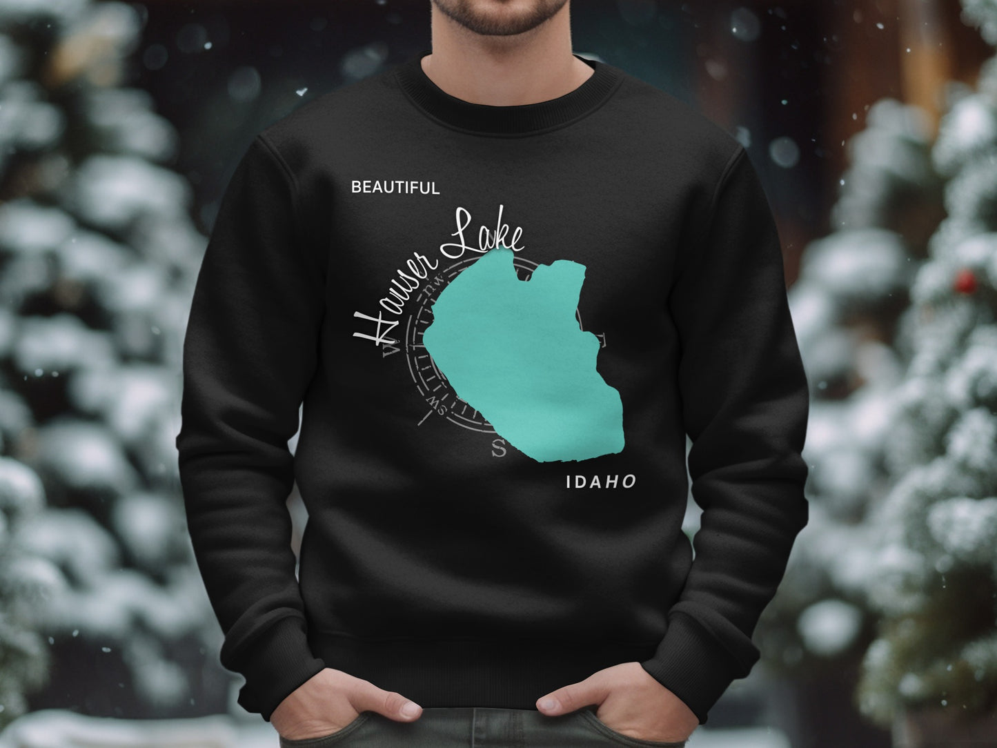 Black sweatshirt with teal Hauser Lake Idaho map and compass graphic.