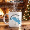 White mug with Lake Wawasee map design, steaming coffee and festive background.