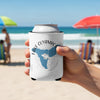 Can cooler with Lake Cuyamaca California map design held by a hand on a beach.