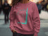 Pink sweatshirt featuring a compass rose and map outline of Lake Vermilion, Minnesota.