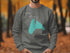 Gray sweatshirt with teal "Beautiful Lake Manawa Iowa" design and compass rose.