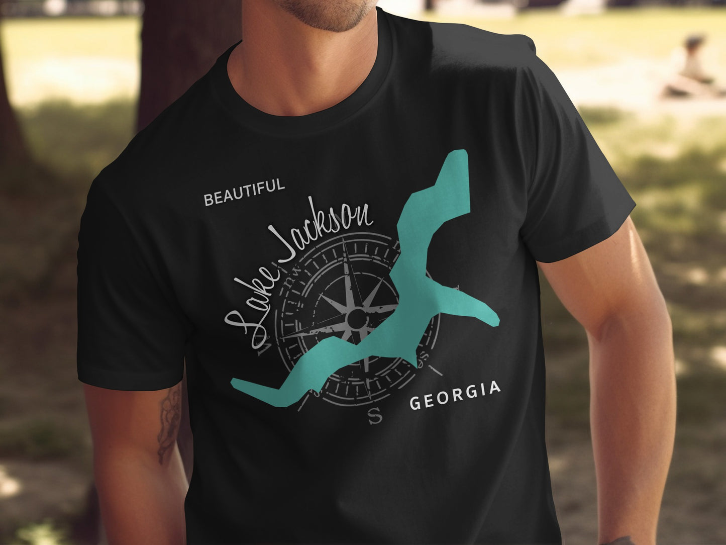 Black t-shirt with a teal map of Lake Jackson, Georgia, and compass graphic.