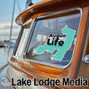 Teal Augur Life logo on a boat window with Lake Lodge Media text.