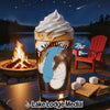 Glass with a Michigan-shaped design filled with a dessert, by a campfire and lake.