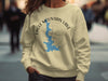 Cream sweatshirt with blue Eagle Mountain Lake map and compass graphic.