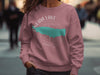 Pink sweatshirt with Oneida Lake New York map graphic and compass design.