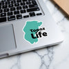 Teal sticker with "Topaz Life" text and copyright on a laptop.