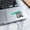Turquoise outline sticker with black text "Lake Dream Life" on a laptop.