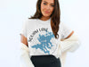 White t-shirt with Squam Lake map and compass design, NH printed below.