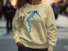 Pale yellow sweatshirt with Lake Jacomo map and compass graphic and "Missouri" text.